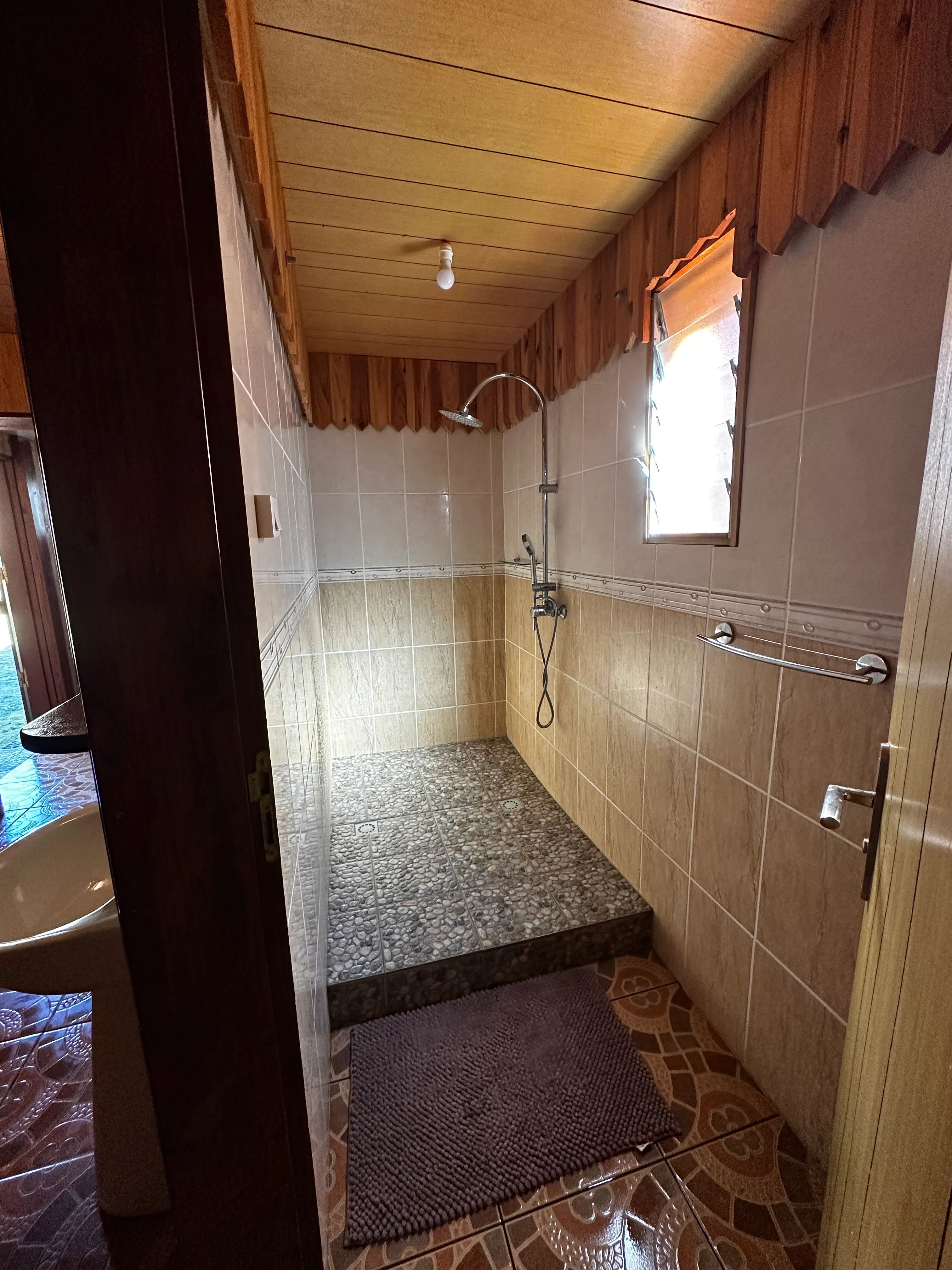 Douche des sanitaires partagés, sol en galets